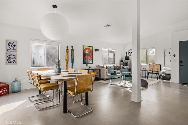 dining room with visible vents and concrete floors