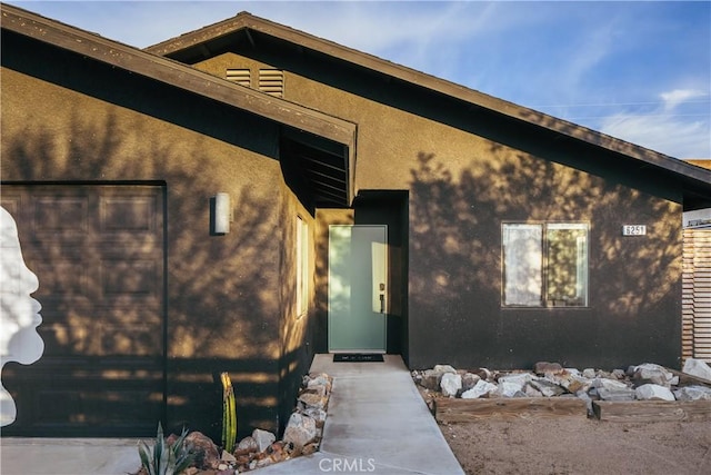 doorway to property with stucco siding