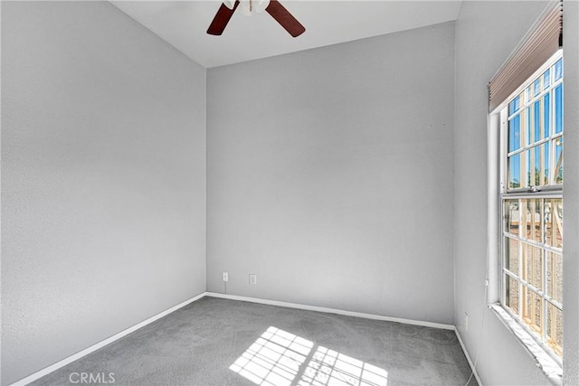 carpeted empty room with plenty of natural light, ceiling fan, and baseboards