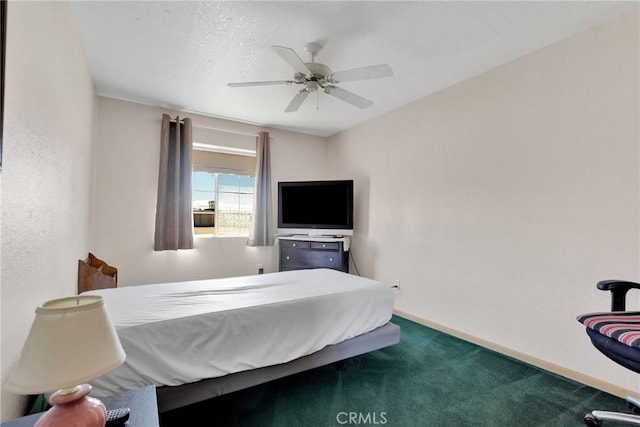 carpeted bedroom featuring baseboards and ceiling fan