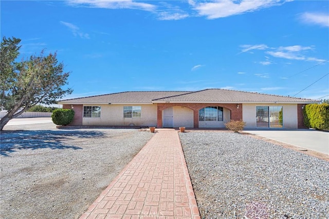 single story home featuring a tile roof and stucco siding