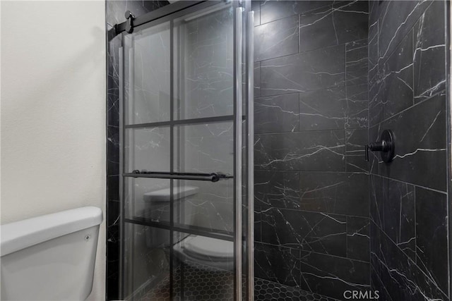 full bathroom with a shower stall and toilet