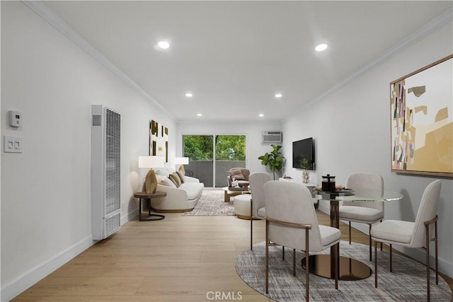 dining room with crown molding, light wood-style floors, a heating unit, and baseboards