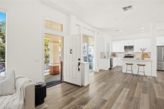 interior space with visible vents, appliances with stainless steel finishes, and a healthy amount of sunlight