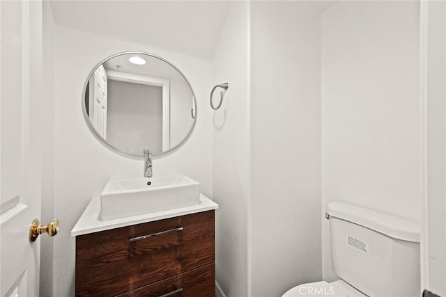 half bath featuring toilet and vanity