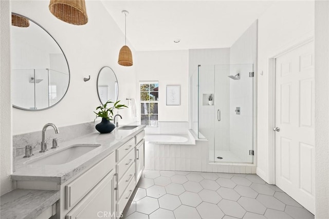 bathroom with a sink, double vanity, a bath, and a shower stall