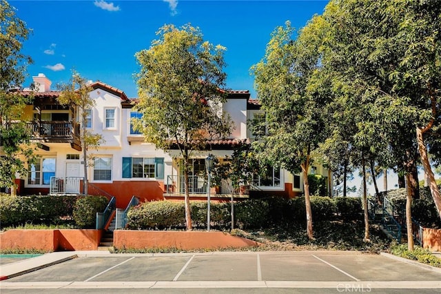 view of front of house featuring stairway and stucco siding