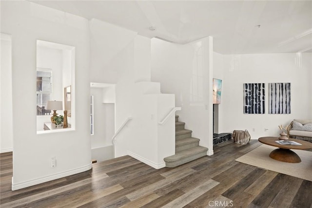 living room featuring stairs and wood finished floors