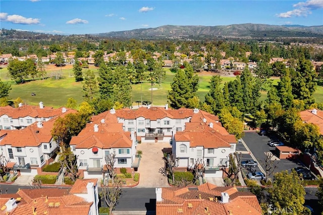 drone / aerial view featuring a mountain view, a residential view, and view of golf course