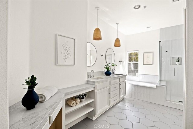 full bathroom with tile patterned floors, a stall shower, vanity, and a washtub