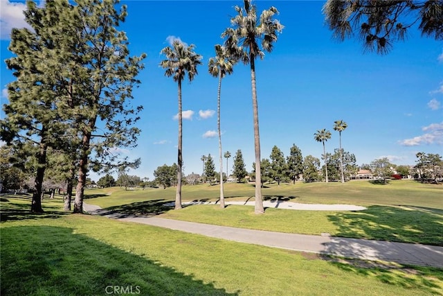 view of home's community with a yard and view of golf course