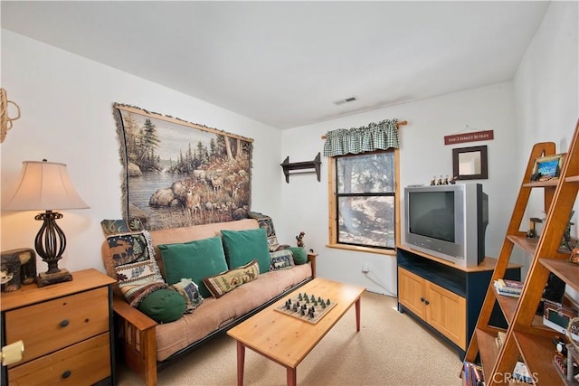 living room with visible vents and light colored carpet