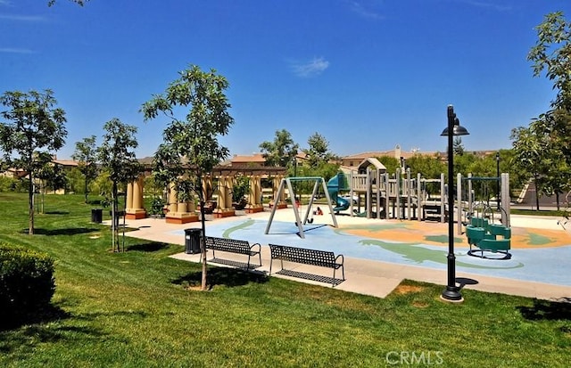 view of home's community with playground community and a yard