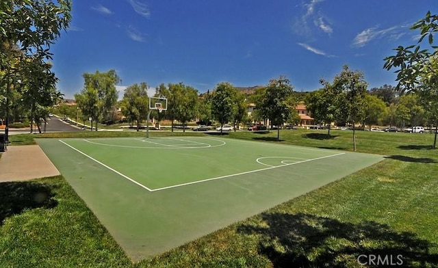 view of sport court with a lawn and community basketball court