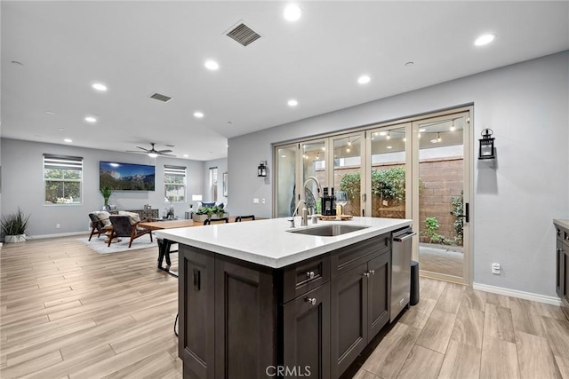 kitchen with visible vents, light wood-style flooring, light countertops, and a sink