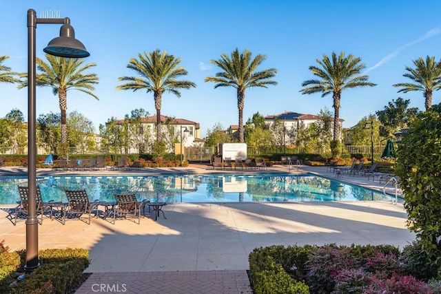 pool featuring a patio and fence