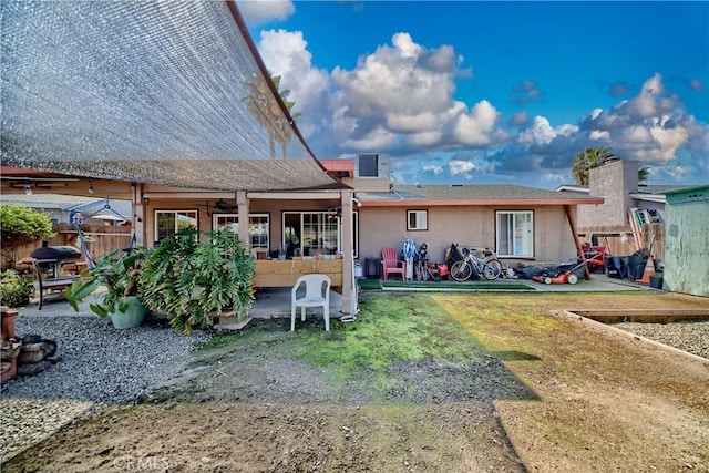 back of house featuring a patio area, stucco siding, ceiling fan, and fence