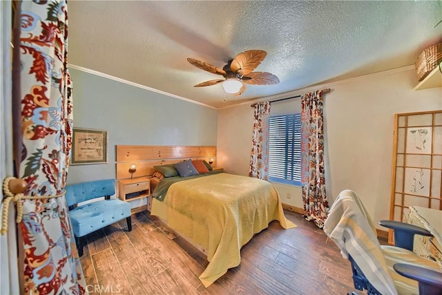 bedroom with a ceiling fan, wood finished floors, and crown molding