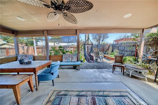 sunroom featuring a wealth of natural light and ceiling fan