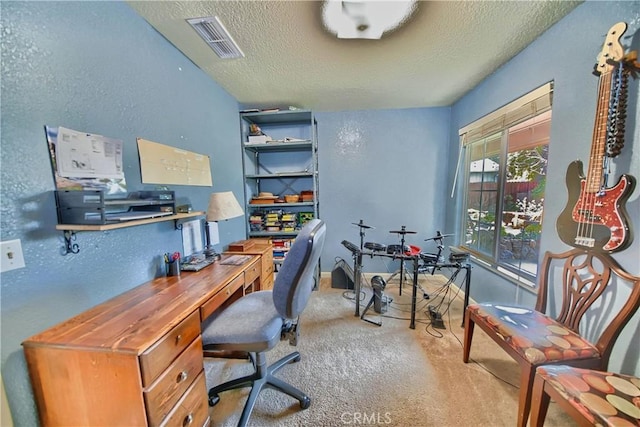 office space with a textured wall, visible vents, carpet floors, and a textured ceiling