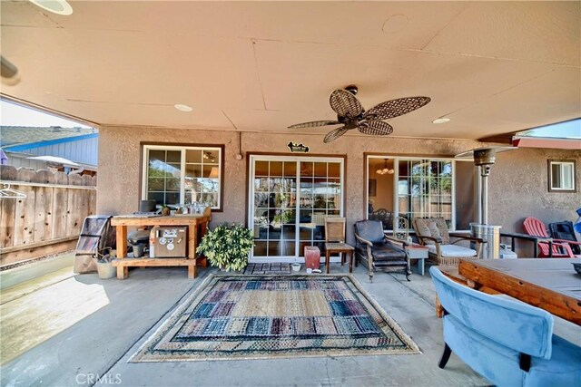 view of patio / terrace featuring ceiling fan and fence