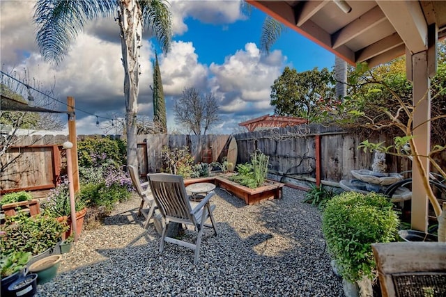 view of yard with a fenced backyard and a garden