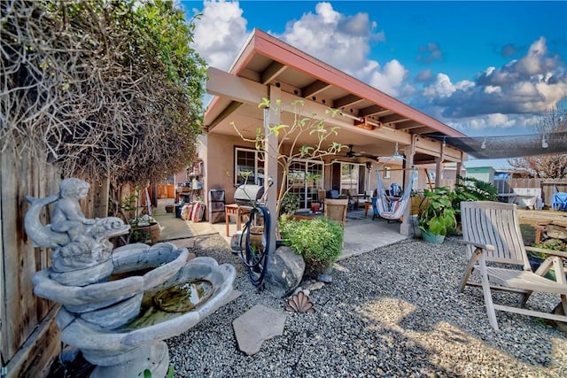 exterior space featuring ceiling fan and fence