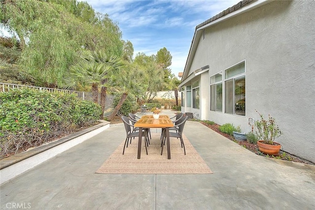 view of patio featuring outdoor dining area and a fenced backyard