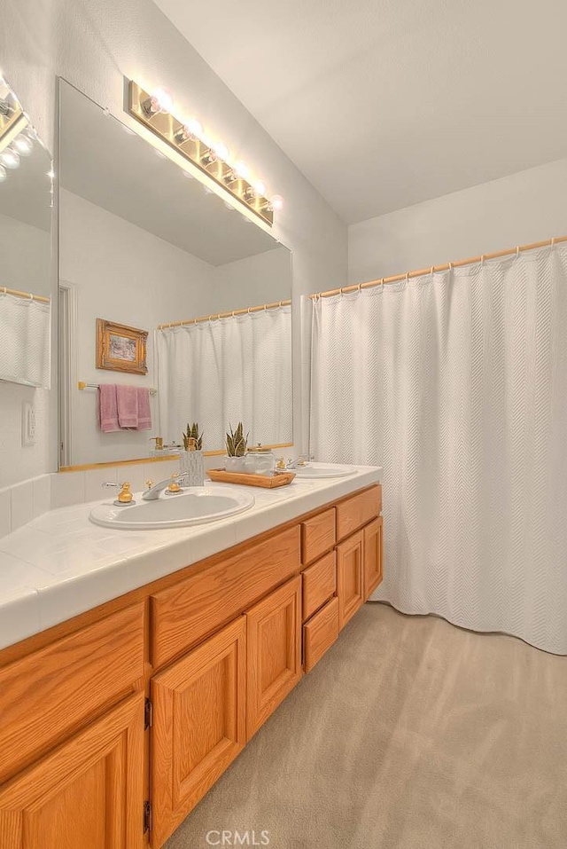 full bath featuring double vanity and a sink