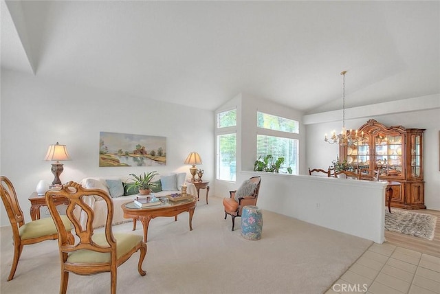 living area with light tile patterned flooring, high vaulted ceiling, and an inviting chandelier