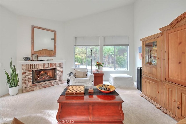 carpeted living area featuring vaulted ceiling and a brick fireplace