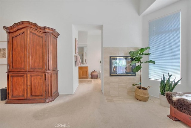 living area featuring carpet flooring and a fireplace