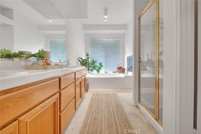 full bath with vanity, a bath, and a stall shower