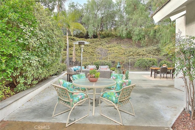 view of patio / terrace with outdoor dining space and fence