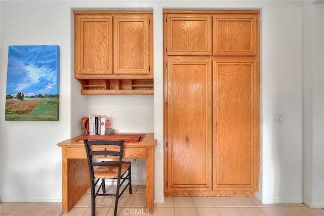 kitchen with brown cabinetry and baseboards