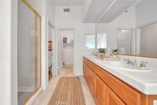 full bathroom with a sink, visible vents, double vanity, and a shower stall