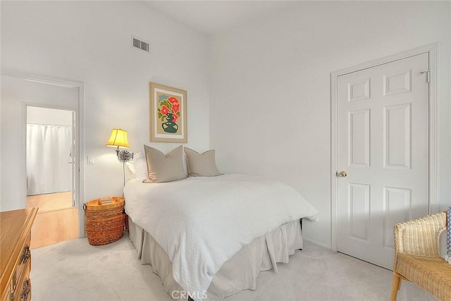 bedroom featuring light carpet and visible vents