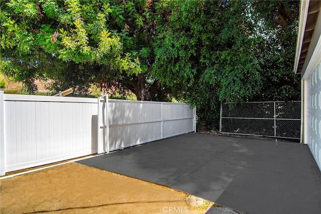 view of patio featuring a gate and fence