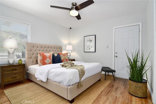 bedroom with light wood-type flooring and a ceiling fan