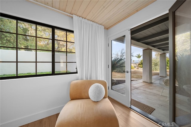 doorway featuring wood ceiling, baseboards, and wood finished floors