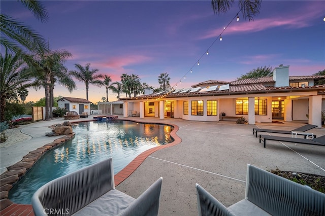 view of pool with french doors, a patio, and a pool with connected hot tub