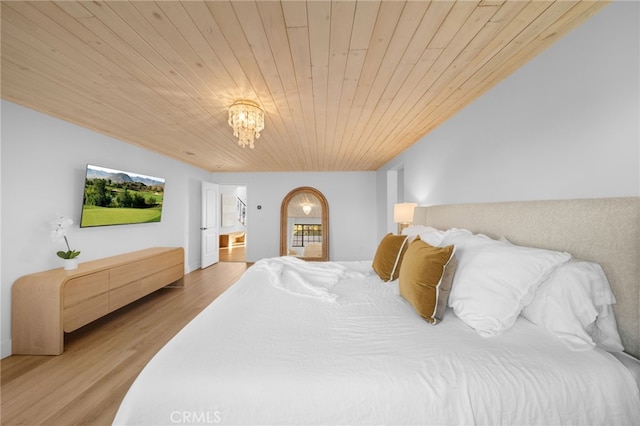 bedroom featuring an inviting chandelier, light wood-style flooring, wood ceiling, and arched walkways