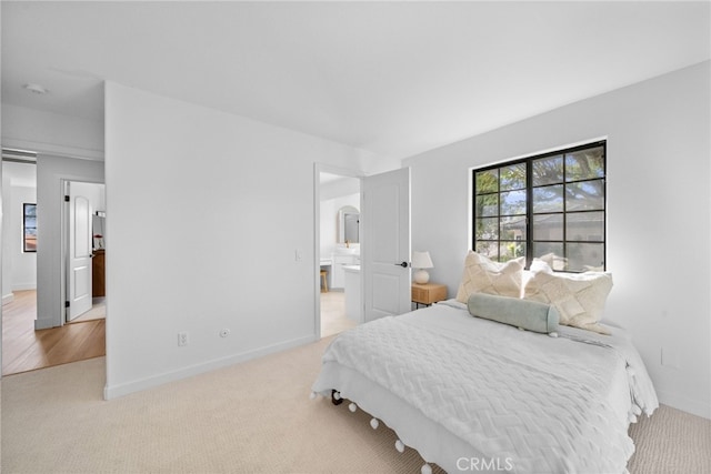 bedroom with baseboards and carpet