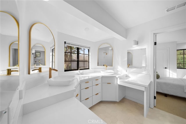 full bathroom with a sink, visible vents, ensuite bath, and double vanity