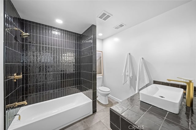 full bath featuring bathtub / shower combination, toilet, visible vents, and a sink