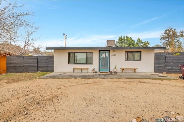 ranch-style home featuring a patio area, a fenced backyard, and stucco siding