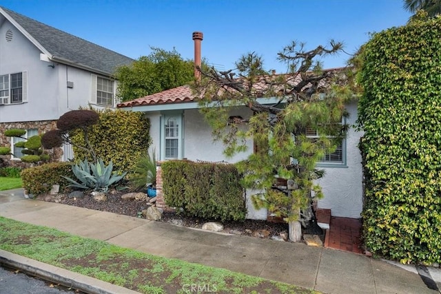 view of side of home featuring stucco siding