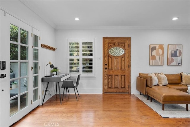 entrance foyer with recessed lighting, light wood-type flooring, and ornamental molding