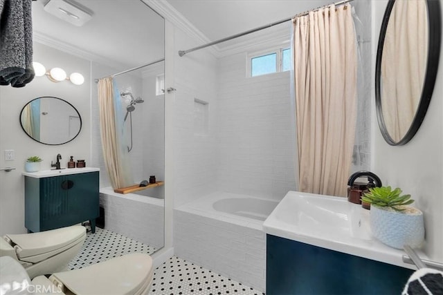 full bathroom featuring vanity, crown molding, toilet, and tiled shower / bath combo