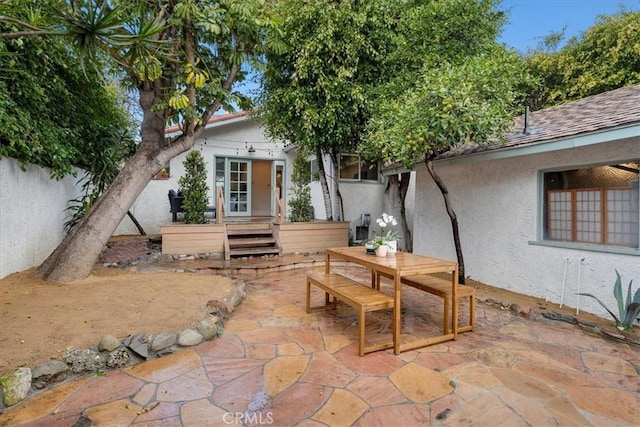 view of patio with outdoor dining space and fence